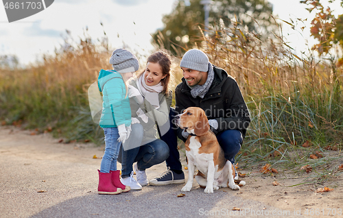 Image of happy family with beagle dog outdoors in autumn