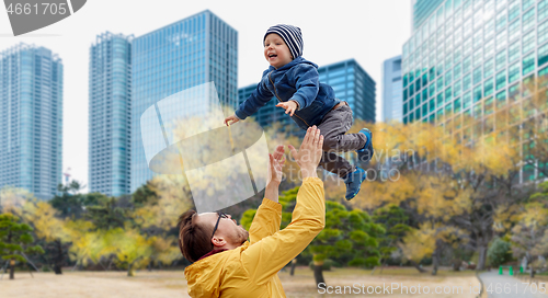 Image of father with son having fun in autumn tokyo city