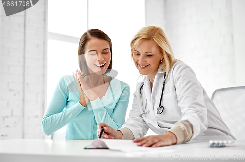 Image of doctor happy woman patient at hospital