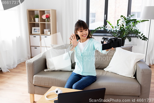 Image of asian female blogger with camera recording video