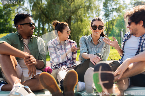 Image of friends hanging out and talking outdoors in summer