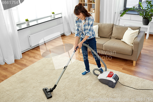 Image of asian woman with vacuum cleaner at home