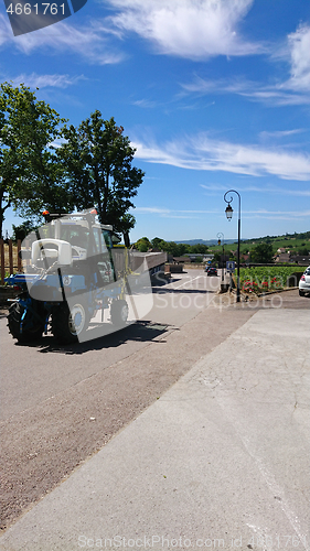 Image of MEURSAULT, BURGUNDY, FRANCE- JULY 9, 2020: Mechanical grape harvester in the Meursault streets, south west of France, Bordeaux