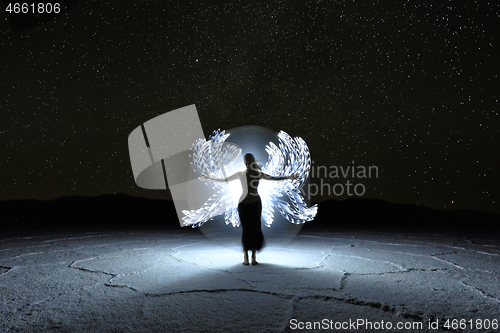 Image of Light Painted Long Exposure Image of a Woman with the Milky Way