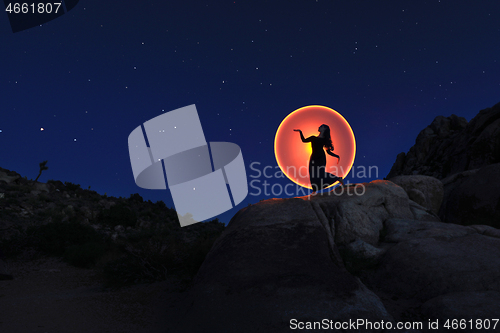 Image of Person Light Painted in the Desert Under the Night Sky