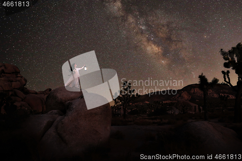 Image of Girl Holding Lantern in the Desert Under the Milky Way