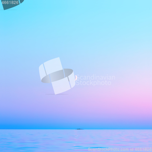 Image of Blue With Pink Night Sky And A Crescent Moon Over The Sea