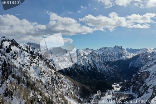 Image of aerial snow covered mountain peaks in alps at winter 