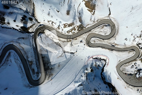 Image of aerial snow covered mountain peaks in alps at winter 