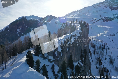 Image of aerial snow covered mountain peaks in alps at winter 