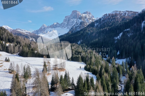 Image of aerial snow covered mountain peaks in alps at winter 