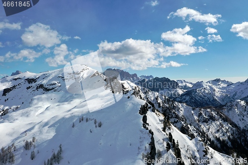 Image of aerial snow covered mountain peaks in alps at winter 