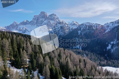 Image of aerial snow covered mountain peaks in alps at winter 