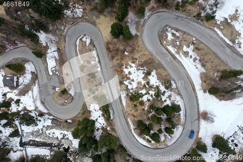 Image of alpine curvy road on winter top view