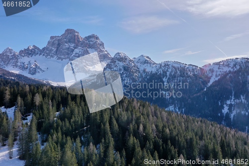 Image of aerial snow covered mountain peaks in alps at winter 