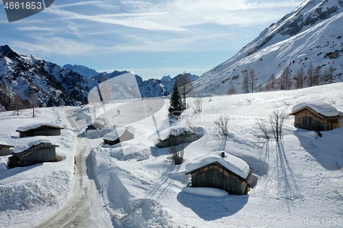 Image of aerial snow covered mountain peaks in alps at winter 