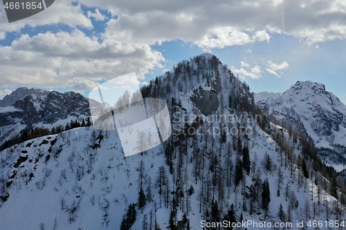 Image of aerial snow covered mountain peaks in alps at winter 