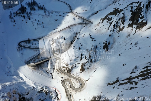 Image of aerial snow covered mountain peaks in alps at winter 