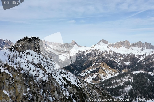 Image of aerial snow covered mountain peaks in alps at winter 