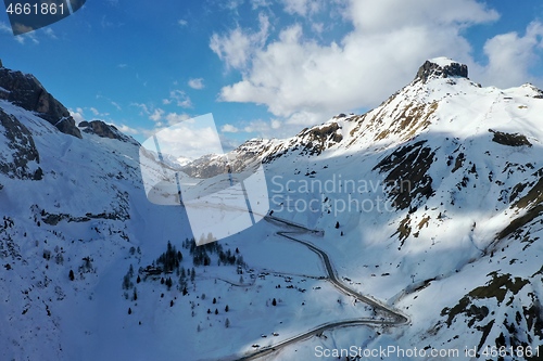 Image of aerial snow covered mountain peaks in alps at winter 