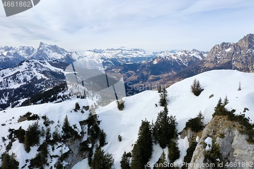 Image of aerial snow covered mountain peaks in alps at winter 