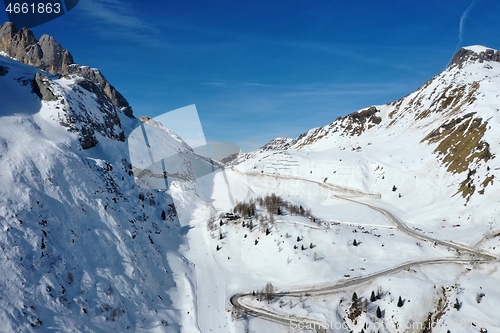 Image of aerial snow covered mountain peaks in alps at winter 