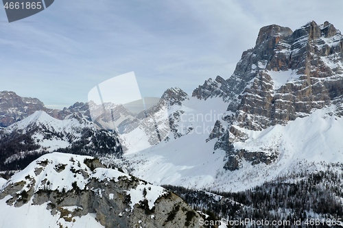 Image of aerial snow covered mountain peaks in alps at winter 