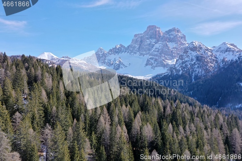 Image of aerial snow covered mountain peaks in alps at winter 