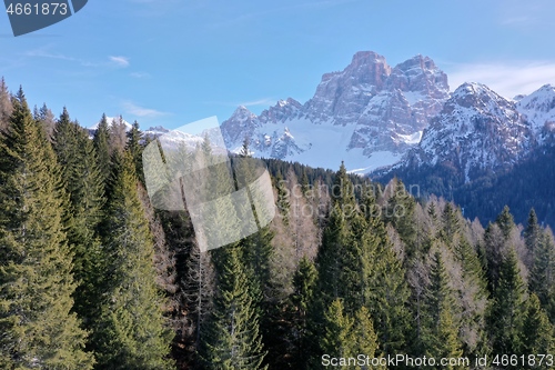 Image of aerial snow covered mountain peaks in alps at winter 