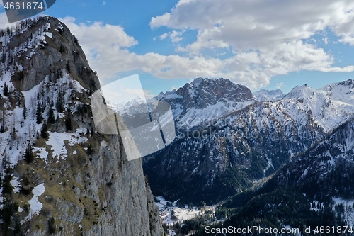 Image of aerial snow covered mountain peaks in alps at winter 