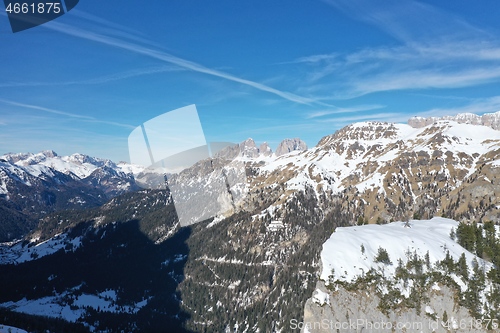 Image of aerial snow covered mountain peaks in alps at winter 