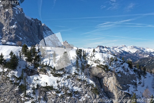 Image of aerial snow covered mountain peaks in alps at winter 