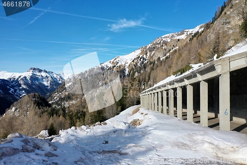 Image of aerial snow covered mountain peaks in alps at winter 