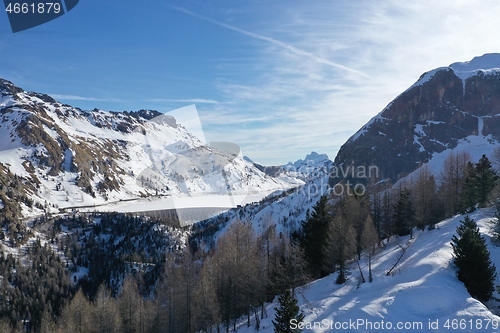 Image of aerial snow covered mountain peaks in alps at winter 