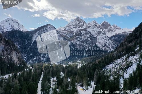 Image of aerial snow covered mountain peaks in alps at winter 