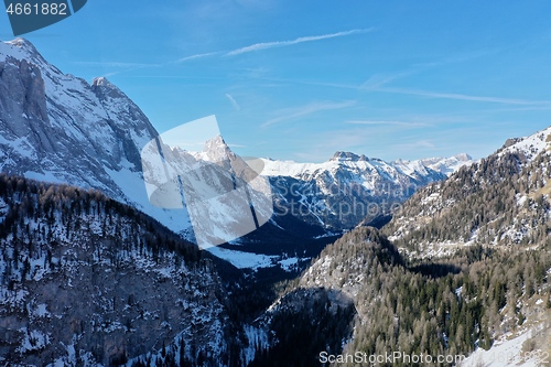 Image of aerial snow covered mountain peaks in alps at winter 