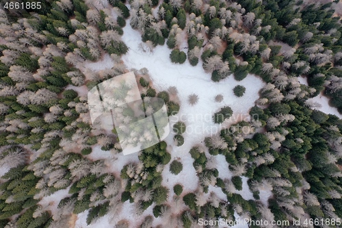 Image of aerial snow covered mountain peaks in alps at winter 