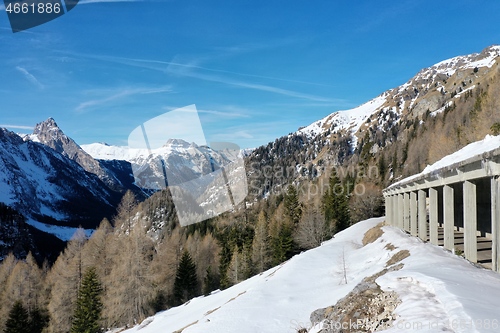 Image of aerial snow covered mountain peaks in alps at winter 