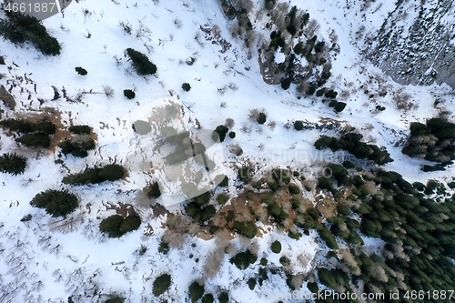 Image of aerial snow covered mountain peaks in alps at winter 