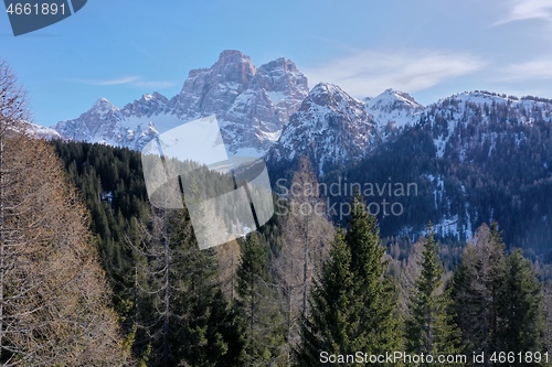 Image of aerial snow covered mountain peaks in alps at winter 