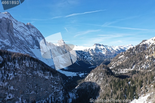 Image of aerial snow covered mountain peaks in alps at winter 