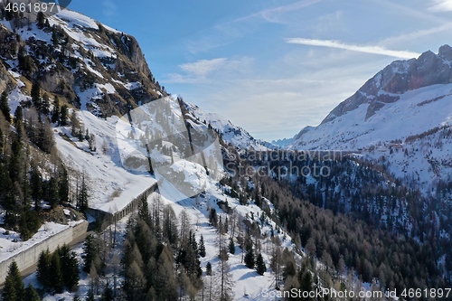 Image of aerial snow covered mountain peaks in alps at winter 