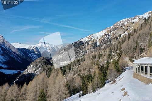 Image of aerial snow covered mountain peaks in alps at winter 