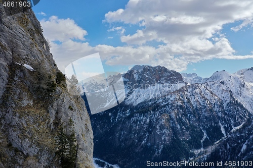 Image of aerial snow covered mountain peaks in alps at winter 