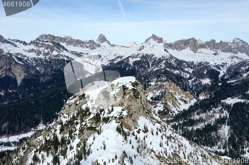 Image of aerial snow covered mountain peaks in alps at winter 