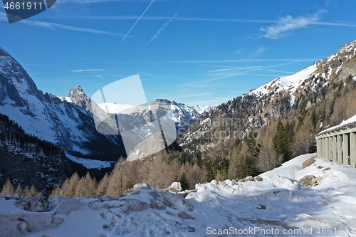 Image of aerial snow covered mountain peaks in alps at winter 