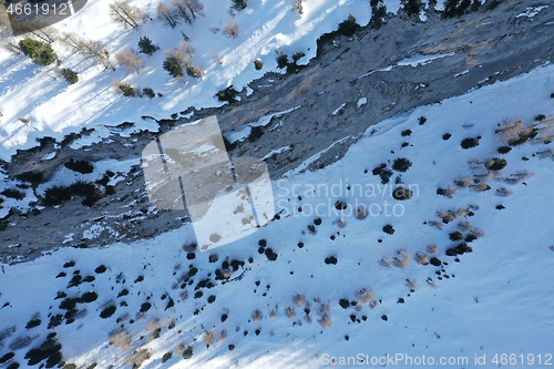 Image of aerial snow covered mountain peaks in alps at winter 