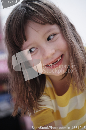 Image of cute little girl at home painting with hands