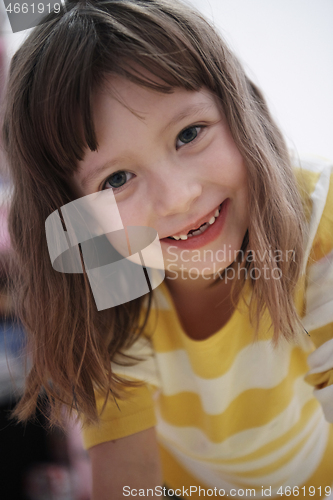 Image of cute little girl at home painting with hands