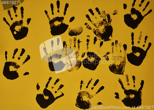 Image of creative children black handprints painting